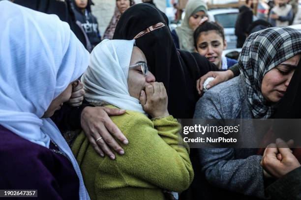 Palestinians are mourning their relatives, who were killed in an Israeli strike on the Al-Maghazi refugee camp, during a mass funeral at the Al-Aqsa...