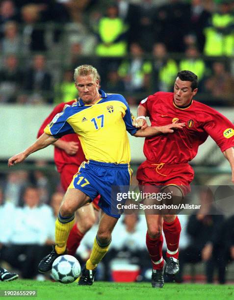 June 10: Eric Deflandre of Belgium and Johan Mjallby of Sweden challenge during the UEFA Euro 2000 Group B match between Belgium and Sweden at King...