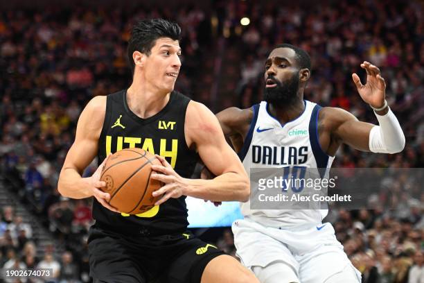 Simone Fontecchio of the Utah Jazz drives past Tim Hardaway Jr. #10 of the Dallas Mavericks during the first half of a game at Delta Center on...