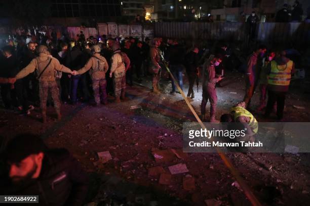 Soldiers of the Lebanese Army near the damaged building that was allegedly targeted by an Israeli drone strike on January 2, 2024 in Dahiyeh, a...