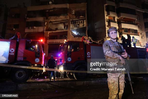 Soldiers of the Lebanese Army near the damaged building that was allegedly targeted by an Israeli drone strike on January 2, 2024 in Dahiyeh, a...