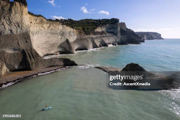 aerial view of corfu, with woman suping below - ionian sea stock pictures, royalty-free photos & images