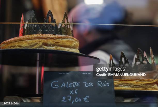 Traditional "galette des rois" baked for the Epiphany's Three Kings Day Christian feast, are on display for sale at a bakery in Paris on January 5,...