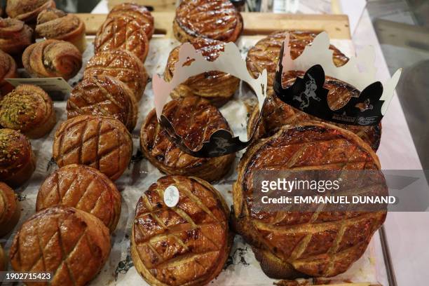 Traditional "galette des rois" baked for the Epiphany's Three Kings Day Christian feast, are on display for sale at a bakery in Paris on January 5,...
