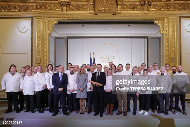 French President Emmanuel Macron flanked by his wife Brigitte Macron and President of the French Bakery and Pastry Federation Dominique Anract ,...
