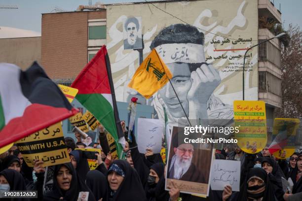 Iranian worshippers are carrying an anti-U.S. And anti-Israeli placard, a portrait of Iran's Supreme Leader Ayatollah Ali Khamenei, Palestinian...
