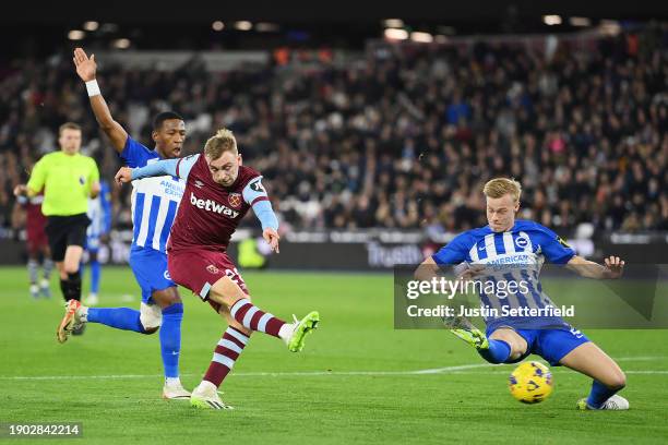 Jarrod Bowen of West Ham United shoots whilst under pressure from Pervis Estupinan and Jan Paul van Hecke of Brighton & Hove Albion during the...