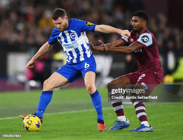 James Milner of Brighton & Hove Albion is challenged by Ben Johnson of West Ham United during the Premier League match between West Ham United and...