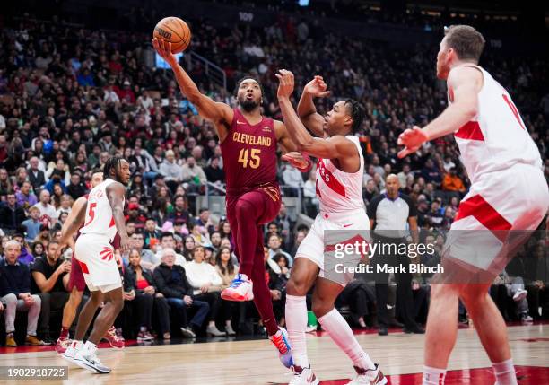 Donovan Mitchell of Cleveland Cavaliers goes to the basket against Scottie Barnes of the Toronto Raptors during the first half of their basketball...