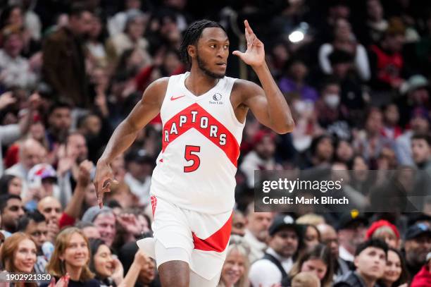 Immanuel Quickley of the Toronto Raptors celebrates a three point shot against the Cleveland Cavaliers during the first half of their basketball game...