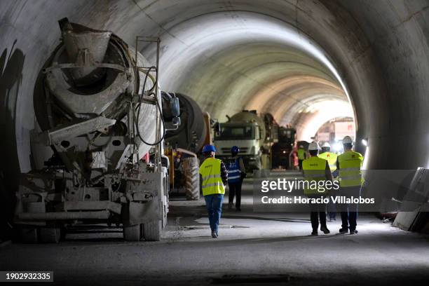 Metro personnel walk by heavy machinery in the tunnel under construction during Portuguese Prime Minister Antonio Costa visit with the Minister of...