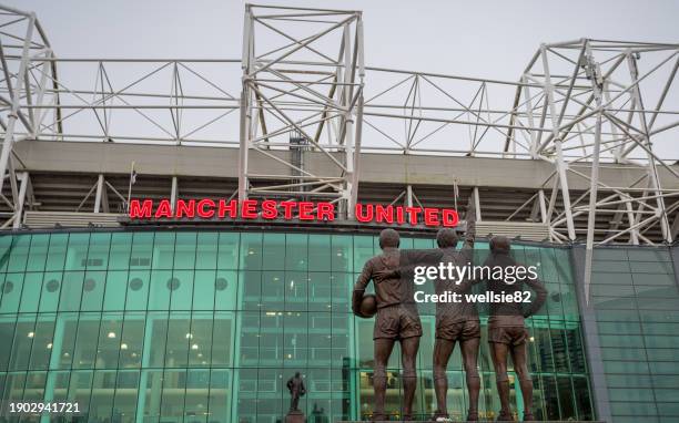 united trinity facing the sir matt busby at old trafford - manchester city premier league stock pictures, royalty-free photos & images