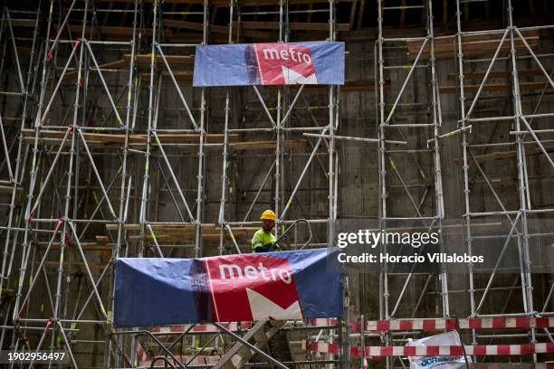 Worker is seen at a scaffold near the bottom of the massive shaft-like structure under construction during Portuguese Prime Minister Antonio Costa...