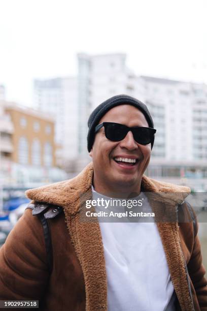 cheerful man in sunglasses and winter jacket by marina - sleeveless sweater stock pictures, royalty-free photos & images