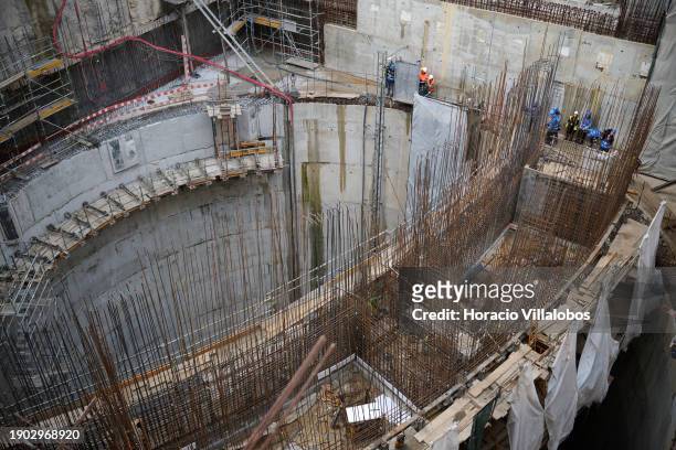 Workers at the massive shaft-like structure under construction during Portuguese Prime Minister Antonio Costa visit with the Minister of the...