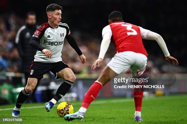 Fulham's Welsh midfielder Harry Wilson vies with Rotherham's English defender Cohen Bramall during the English FA Cup third round football match...