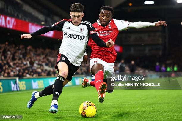 Fulham's Welsh midfielder Harry Wilson vies with Rotherham's English defender Sebastian Revan during the English FA Cup third round football match...