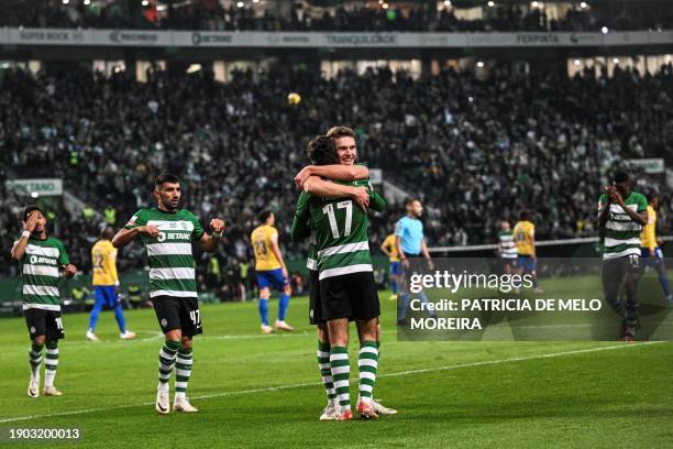 Sporting's Portuguese forward Francisco Trincao celebrates with his teammate Sporting's Portuguese forward Viktor Gyokeres after scoring during the...