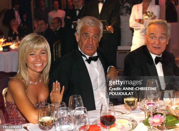 The companion of French actor Jean-Paul Belmondo , Natty and French actor and director Philippe Labro, member of the jury, attend the reception...