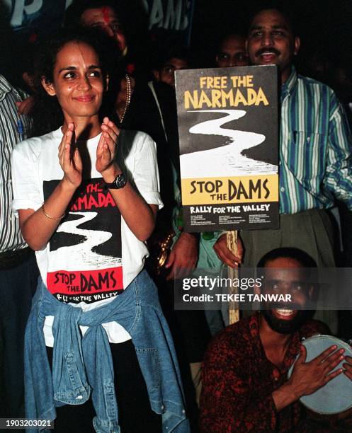 Indian Booker prize-winning author Arundhati Roy claps her hands during a demonstration on the platform of a Delhi railway station 29 July 1999,...