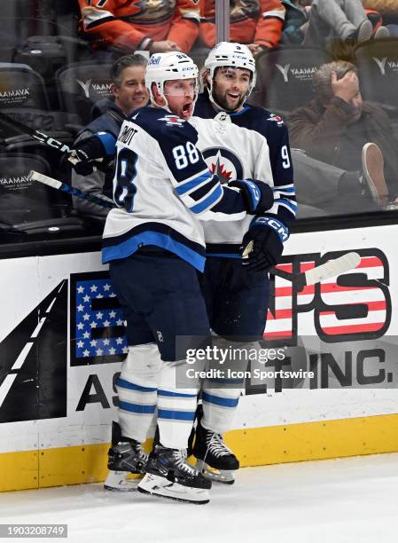 Winnipeg Jets defenseman Nate Schmidt and right wing Alex Iafallo celebrate after Schmidt scored a goal in the third period of an NHL hockey game...