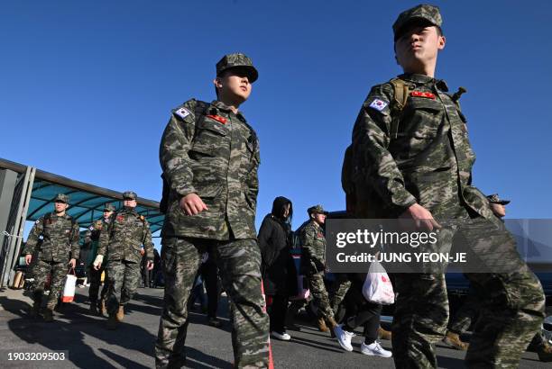 South Korean marines disembark from a passenger ferry at Yeonpyeong island, near the 'northern limit line' sea boundary with North Korea, on January...