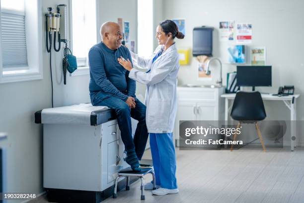 senior medical check-up - adult patient with doctor and stethoscope stock-fotos und bilder