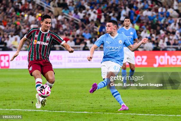 Phil Foden of Manchester City attempts a kick while being defended by Paulo Henrique Ganso of Fluminense during the FIFA Club World Cup Final match...