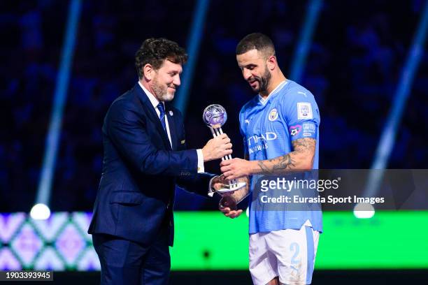 President of CONMEBOL Alejandro Dominguez awards Kyle Walker of Manchester City with Adidas Silver Ball during the FIFA Club World Cup Final match...