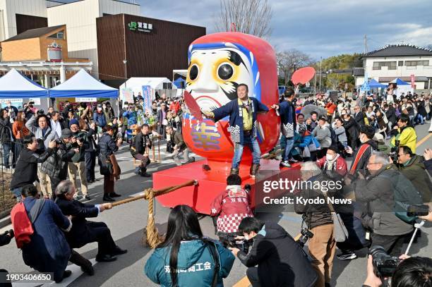 Gigantic red "daruma" doll, a popular talisman of good luck, is displayed during a New Year daruma market in the northeastern Japan town of Futaba --...