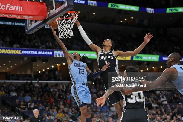 Ja Morant of the Memphis Grizzlies goes to the basket against Victor Wembanyama of the San Antonio Spurs during the first half at FedExForum on...