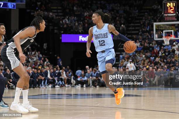 Ja Morant of the Memphis Grizzlies handles the ball against Devin Vassell of the San Antonio Spurs during the first half at FedExForum on January 02,...