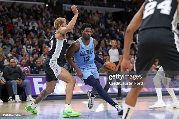 Jaren Jackson Jr. #13 of the Memphis Grizzlies drives to the basket against Jeremy Sochan of the San Antonio Spurs during the first half at...