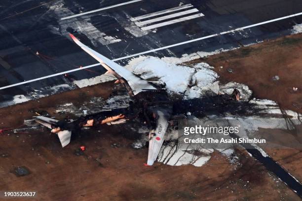 In this aerial image, the debris of Airbus A-350, Flight JAL 516 is seen a day after the collision with a Japan Coast Guard aircraft at Haneda...