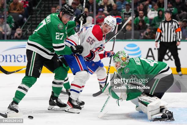 Goaltender Scott Wedgewood and Mason Marchment of the Dallas Stars defend against Michael Pezzetta of the Montreal Canadiens in front of the net in...