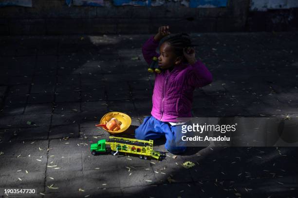 Migrant child from Haiti plays in a makeshift camp of tents at the Giordano Bruno Park, in Mexico City, Mexico on January 05, 2024. Dozens of...