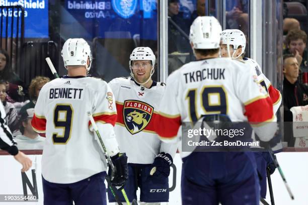 Carter Verhaeghe of the Florida Panthers celebrates a goal during the first period against the Arizona Coyotes with Sam Bennett, and Matthew Tkachuk...