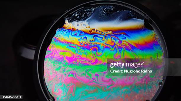 swirl rainbow iridescence soap film layer - bubble ring stock pictures, royalty-free photos & images