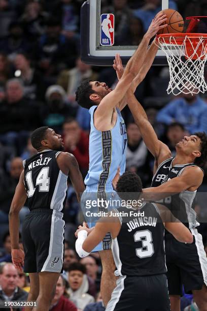 Santi Aldama of the Memphis Grizzlies goes to the basket against Dominick Barlow of the San Antonio Spurs during the second half at FedExForum on...