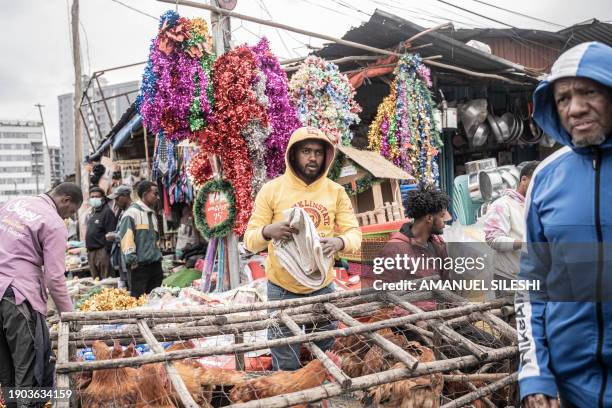 People trade live chickens at a market in the Shola district ahead of the Ethiopian Orthodox Christmas celebrations in Addis Ababa on January 6,...