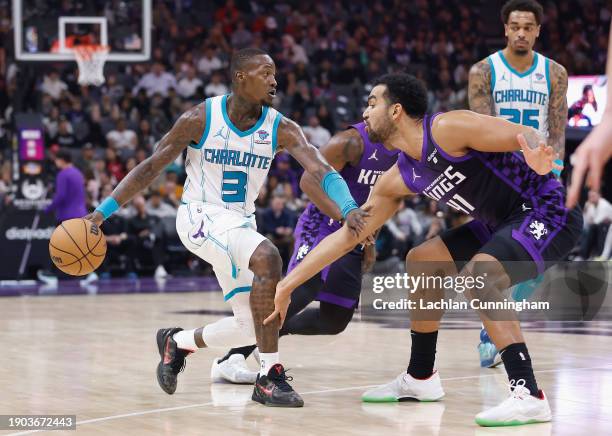 Terry Rozier of the Charlotte Hornets is guarded by of the Sacramento Kings in the second quarter at Golden 1 Center on January 02, 2024 in...