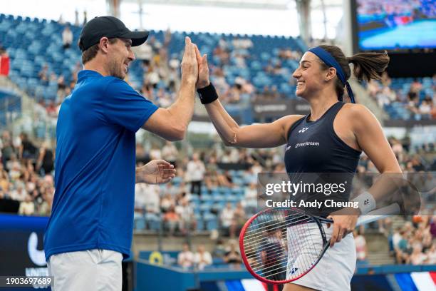 Caroline Garcia of Team France celebrates with team captain Edouard Roger-Vasselin after match point in their Group D match against Jasmine Paolini...