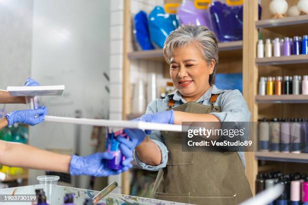 4k asian senior woman learning acrylic pouring art. - acrylic paints stock pictures, royalty-free photos & images