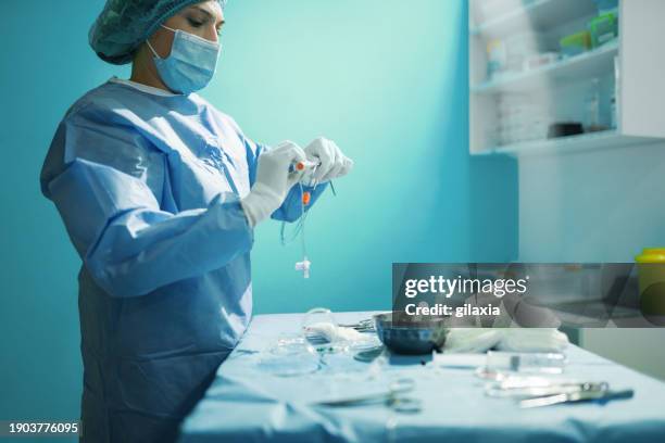 surgical procedure preparation. - blue surgical mask stock pictures, royalty-free photos & images