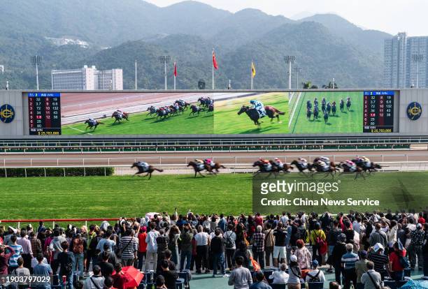 Spectators watch horse race during the 2024 Hong Kong New Year's Day Race Meeting 'Lucky Start January 1, 2024' at Sha Tin Racecourse on January 1,...