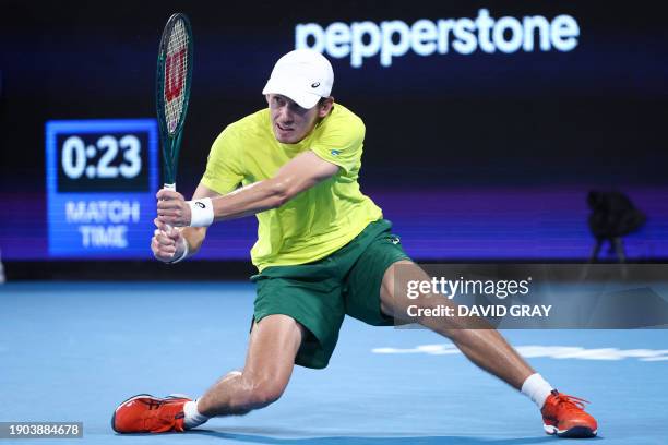 Australia's Alex De Minaur hits a return against Germany's Alexander Zverev during their men's singles match at the United Cup tennis event on Ken...