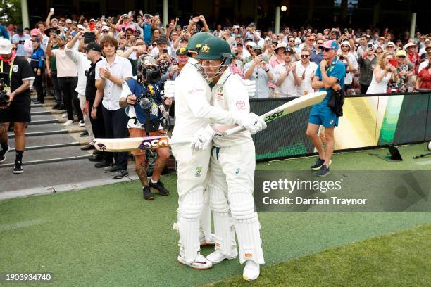 David Warner and Usman Khawaja of Australia embrace before they take to the field during day one of the Men's Third Test Match in the series between...