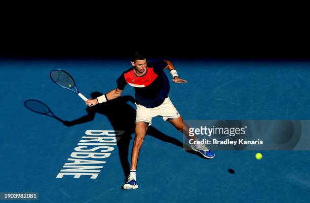 Alexei Popyrin of Australia plays a forehand in his match against Roman Safiullin of Russia during day four of the 2024 Brisbane International at...