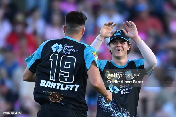 Mitch Swepson of the Heat celebrates with Xavier Bartlett after Jordan Silk of the Sixers was bowled out by Xavier Bartlett during the BBL match...