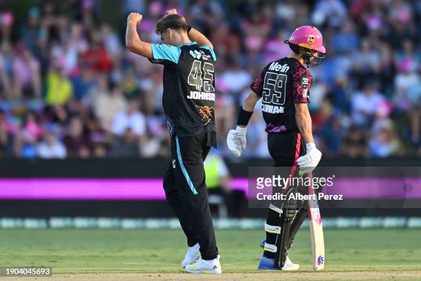Spencer Johnson of the Heat celebrates dismissing Tom Curran of the Sixers during the BBL match between Sydney Sixers and Brisbane Heat at Coffs...